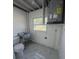 Utility room featuring a sink, toilet, and water heater at 547 16Th S Ave, St Petersburg, FL 33701