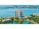 Gorgeous aerial view highlights a waterfront condo with a pond, mature landscaping, and convenient parking at 6287 Bahia Del Mar Cir # 801, St Petersburg, FL 33715