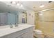 Well-lit bathroom with a vanity, toilet, and enclosed shower at 6287 Bahia Del Mar Cir # 801, St Petersburg, FL 33715