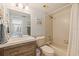 Cozy bathroom has a shower-tub combo, wood vanity, and neutral tile at 6287 Bahia Del Mar Cir # 801, St Petersburg, FL 33715