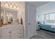 Bathroom featuring a clear glass sink, white cabinetry, and modern finishes at 6287 Bahia Del Mar Cir # 801, St Petersburg, FL 33715
