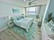 Bright bedroom with calming blue accents, a bed, water views, and wood floors at 6287 Bahia Del Mar Cir # 801, St Petersburg, FL 33715