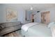 Comfortable bedroom featuring light blue walls, a ceiling fan, and a gray couch at 6287 Bahia Del Mar Cir # 801, St Petersburg, FL 33715