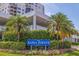 Bahia Pointe building entrance featuring lush landscaping, a colorful sign, and views of the modern architecture at 6287 Bahia Del Mar Cir # 801, St Petersburg, FL 33715