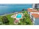 Aerial shot of a community pool and hot tub surrounded by palm trees and green lawn at 6287 Bahia Del Mar Cir # 801, St Petersburg, FL 33715