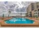 Inviting pool with lounge chairs and umbrellas overlooking a picturesque waterfront view at 6287 Bahia Del Mar Cir # 801, St Petersburg, FL 33715