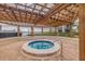 Relaxing hot tub with a wooden pergola offering shade and scenic waterfront views at 6287 Bahia Del Mar Cir # 801, St Petersburg, FL 33715