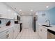 Spacious kitchen featuring updated appliances, white cabinets, and tile flooring at 6287 Bahia Del Mar Cir # 801, St Petersburg, FL 33715