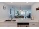Modern kitchen with a breakfast bar overlooking the light and bright living area with water views at 6287 Bahia Del Mar Cir # 801, St Petersburg, FL 33715