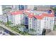 An aerial view showcases the community, the pool and spa, palm trees and other landscaping, and nearby docks at 700 S Harbour Island Blvd # 342, Tampa, FL 33602