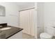 Functional bathroom featuring a tile floor, granite vanity, toilet, and a shower with curtain for privacy at 700 S Harbour Island Blvd # 342, Tampa, FL 33602