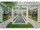 A landscaped courtyard with a long fountain, plants, flowers, benches, and white pillars and trellis at 700 S Harbour Island Blvd # 342, Tampa, FL 33602
