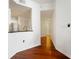 Hallway with hardwood floors leading to the kitchen with stainless steel appliances, and a white door at 700 S Harbour Island Blvd # 342, Tampa, FL 33602