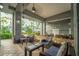 An outdoor patio with comfortable furniture and ceiling fans, overlooking the landscaped courtyard at 700 S Harbour Island Blvd # 342, Tampa, FL 33602