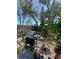 Backyard area with outdoor grill, patio, and lush vegetation around the perimeter at 7421 Mulligan Ct, Port Richey, FL 34668