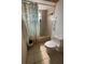 Modest bathroom featuring a shower/tub combo with tile surround and a patterned shower curtain at 7421 Mulligan Ct, Port Richey, FL 34668