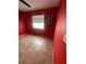 Bedroom featuring red walls, a ceiling fan, and a window with a motivational sign at 7421 Mulligan Ct, Port Richey, FL 34668