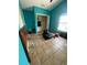 Turquoise bedroom with a window, closet, and tile floors at 7421 Mulligan Ct, Port Richey, FL 34668