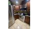 Well-equipped kitchen features stainless steel appliances, wine rack and dark wood cabinetry at 7421 Mulligan Ct, Port Richey, FL 34668