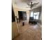 Bright sunroom with tile flooring, ceiling fan, furniture and access to the outdoors at 7421 Mulligan Ct, Port Richey, FL 34668