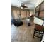 Bright sunroom with tile flooring, ceiling fan and a relaxing chair at 7421 Mulligan Ct, Port Richey, FL 34668