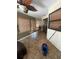 Bright sunroom with tile flooring, ceiling fan and natural light from many windows at 7421 Mulligan Ct, Port Richey, FL 34668