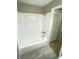 Bathroom showcasing the clean white tub and shower with chrome fixtures at 8310 Croton Ave, Tampa, FL 33619