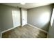 A simple bedroom with neutral paint, wood-look tile, and a closet at 8310 Croton Ave, Tampa, FL 33619
