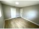 Bright bedroom with wood-look tile flooring, white trim, and features a closet and an additional door at 8310 Croton Ave, Tampa, FL 33619