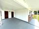 A covered carport area features dual entry doors and a brick accent wall at 8310 Croton Ave, Tampa, FL 33619