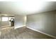Open concept living area with wood-look tile flooring and view to the kitchen at 8310 Croton Ave, Tampa, FL 33619