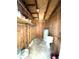 Unfinished utility room with shelving, a water heater, and toilet at 8310 Croton Ave, Tampa, FL 33619