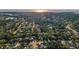 Scenic aerial view featuring a neighborhood near the water with lush trees and well-spaced homes at 833 Lakeside Ter, Palm Harbor, FL 34683