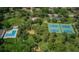 Aerial view of community amenities including tennis courts, playground, and community pool at 833 Lakeside Ter, Palm Harbor, FL 34683