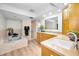 Bright bathroom features a soaking tub, wood cabinets, and quartz countertops at 833 Lakeside Ter, Palm Harbor, FL 34683