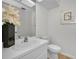 Neutral toned half-bathroom with white countertop, decor, and modern fixtures at 833 Lakeside Ter, Palm Harbor, FL 34683