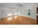 Spacious and bright bedroom with hardwood flooring, ceiling fan, and natural light at 833 Lakeside Ter, Palm Harbor, FL 34683