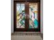 Close-up of a modern-designed front door featuring unique glass patterns and silver hardware at 833 Lakeside Ter, Palm Harbor, FL 34683