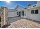 Inviting front entrance with a stone-paved patio and natural stone pillar accents at 833 Lakeside Ter, Palm Harbor, FL 34683