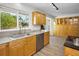 A bright kitchen featuring wooden cabinets, stainless steel appliances, and a view of the yard, enhancing the cooking atmosphere at 833 Lakeside Ter, Palm Harbor, FL 34683