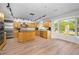 A spacious kitchen with wooden cabinets, an island, and a large window, providing ample cooking space and natural light at 833 Lakeside Ter, Palm Harbor, FL 34683