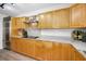 Kitchen area with wooden cabinets, stainless steel appliances, and granite countertops, offering a modern cooking experience at 833 Lakeside Ter, Palm Harbor, FL 34683