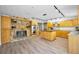 A spacious kitchen with wooden cabinets, stainless steel appliances, and stone fireplace, blending rustic with modern at 833 Lakeside Ter, Palm Harbor, FL 34683