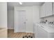 Laundry room with white cabinets and modern appliances at 833 Lakeside Ter, Palm Harbor, FL 34683