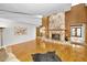 Spacious living room with hardwood floors, stone fireplace, and wood paneled walls at 833 Lakeside Ter, Palm Harbor, FL 34683