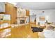 Expansive living room with hardwood floors, stone fireplace, and views into the kitchen at 833 Lakeside Ter, Palm Harbor, FL 34683