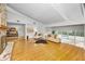 Open living room with stone fireplace, hardwood floors, and a view of the backyard and patio at 833 Lakeside Ter, Palm Harbor, FL 34683