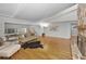 Bright living room features a stone fireplace, hardwood floors, and access to an outdoor entertainment area at 833 Lakeside Ter, Palm Harbor, FL 34683