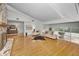 Open-concept living room with hardwood floors, stone fireplace, and a sliding glass door to the backyard at 833 Lakeside Ter, Palm Harbor, FL 34683