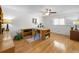 Bright home office features hardwood floors, a ceiling fan, built-in shelving, and a large window at 833 Lakeside Ter, Palm Harbor, FL 34683